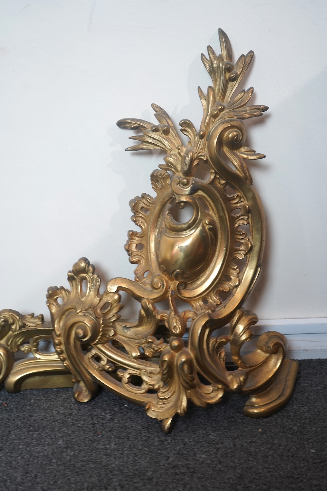 A French rococo revival ormolu adjustable fender with chenets, late 19th century